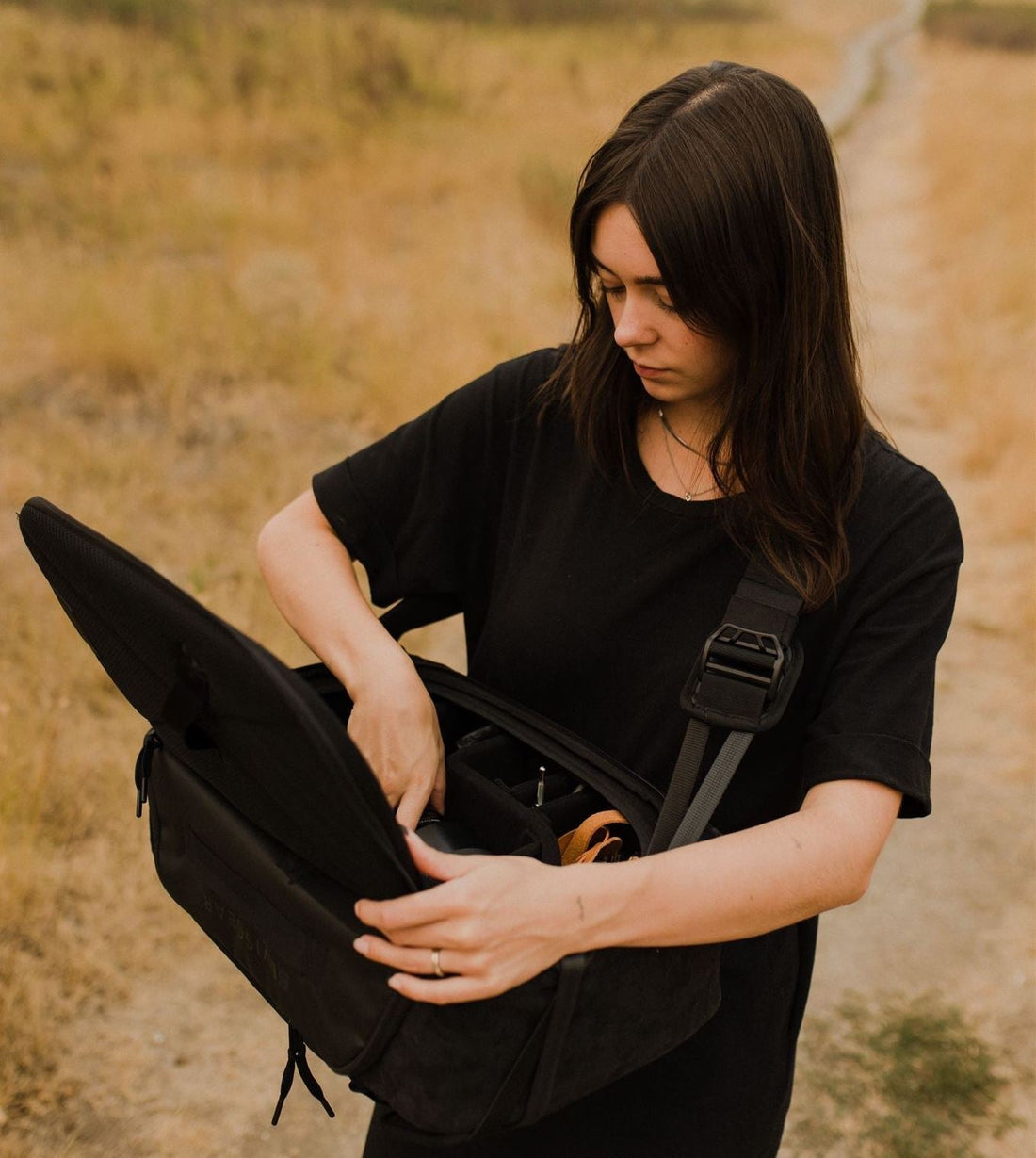 Rebecca hold the top shelf fast access camera bag