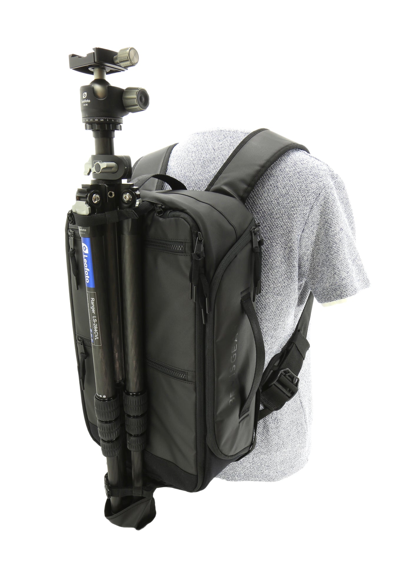 Model with a  grey sweater wearing the Bevis Gear Top Shelf bag as a backpack demonstrating how the hidden straps can secure a tripod